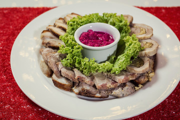 Food tray with delicious rolls, boiled pork served with marinated horseradish called as meat platter