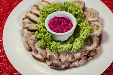 Food tray with delicious rolls, boiled pork served with marinated horseradish called as meat platter