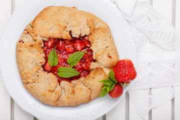 Strawberry galette. Homemade healthy wholegrain berry open pie. Fruit tart. Top view.
