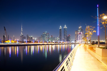 Fototapeta premium DUBAI, UAE - FEBRUARY 2018: Colorful sunset over Dubai Downtown skyscrapers and the newly built Tolerance bridge as viewed from the Dubai water canal.