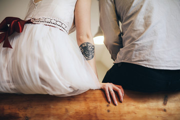The lovely couple in love embracing and sitting in the room