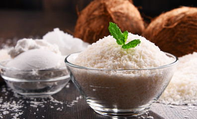 Composition with bowl of shredded coconut and shells