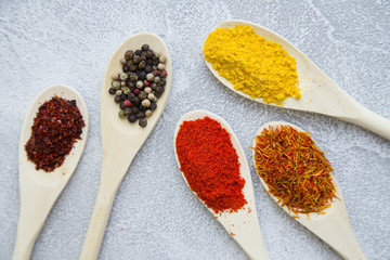 Set of spices and herbs on light stone background