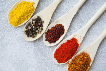 Set of spices and herbs on light stone background