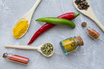 Set of spices and herbs on light stone background