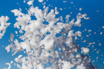Fototapeta premium White foam against the blue sky as background