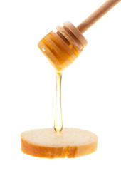 Honey is applied to the surface of bread. Isolated on a white background.