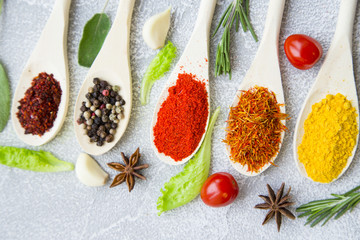 Set of spices and herbs on light stone background