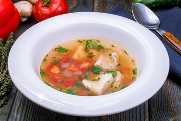 Fish soup on white plate