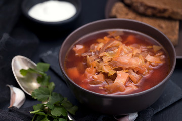 traditional russian beetroot soup in brown bowl