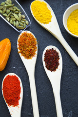 Set of specis and herbs on black stone background