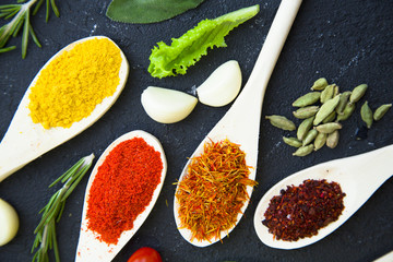 Set of specis and herbs on black stone background
