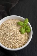 uncooked quinoa in white bowl