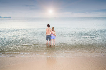 Back view Young Couple romantic travel honeymoon on Beach