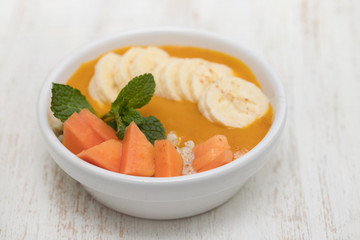 healthy and tasty breakfast with mango in white bowl