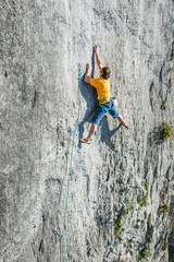 Young man climbing extreme hard route on limestone rocks