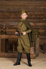 Russian boy in the old-fashioned Soviet military uniform