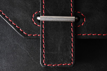 black leather stitched with red thread