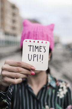woman with a pink hat and the text time is up