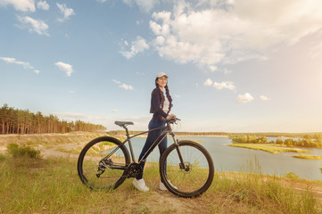 Vacation time. Hipster woman traveling with bicycle on the forest relax time and holiday, color sport style selective and soft focus