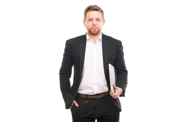 Studio portrait of young manager in suit holding laptop on white background