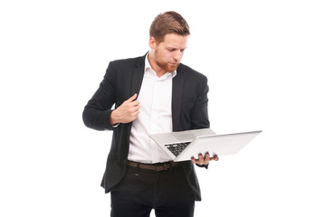 Studio portrait of young manager in suit holding laptop on white background