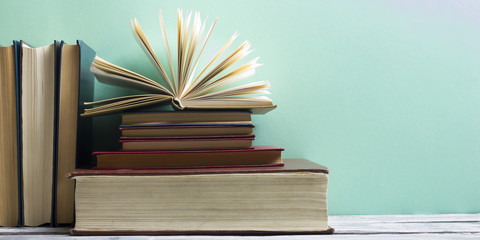 Open book, hardback books on wooden table. Back to school. Copy space