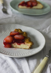 Home made strawberry pie in white plate on table