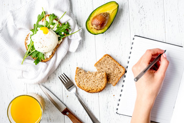sandwich with poached eggs on wooden background top view mockup