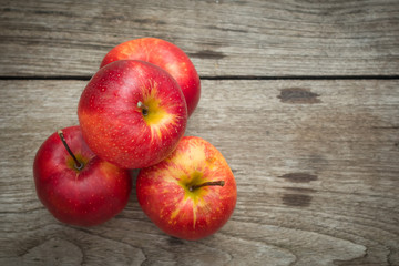 Red apples on a wooden table background