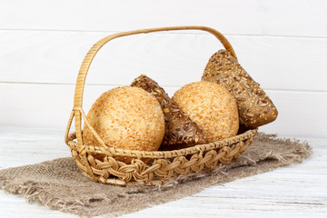 A fresh basket of golden brown hard crusted buns. Shot on white background