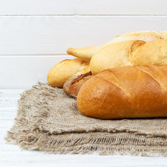 Bakery background, bread assortment. Rye buns and french baguettes top view