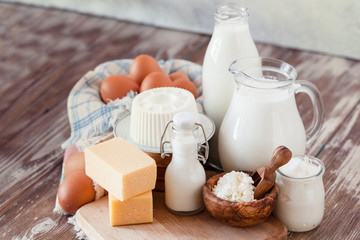 Set of different milk products on ristic wooden table