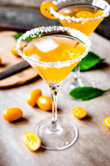 cocktail with kumquat on wooden background