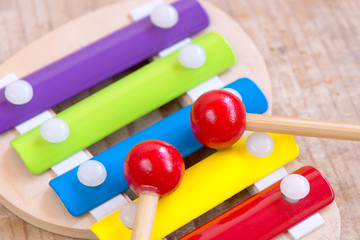 Toy xylophone on wooden background