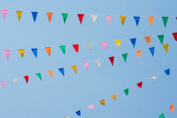 Colorful bunting flags with blue sky 