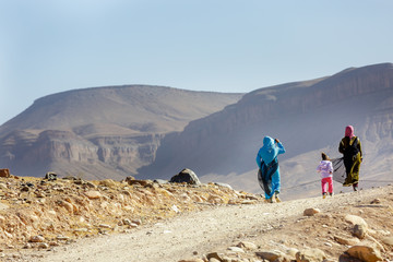 Women with child walking in desert