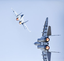Two Fast Fighter Jets Battle Clear sky