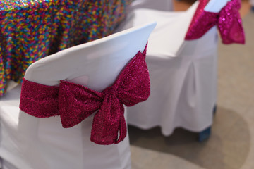 Design of Red bow Decorated on Chairs at Chinese table dinner for wedding party or event