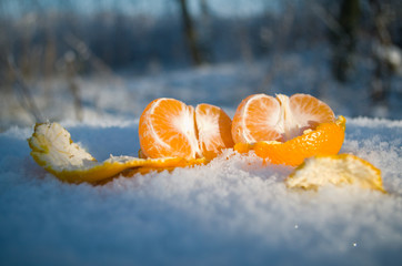 Peeled mandarin orange on a snow