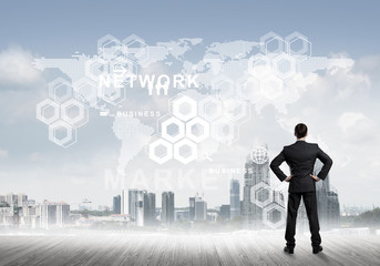 Pensive businessman looking at user interface against modern city background