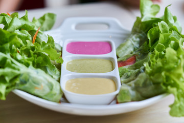 healthy food, Fresh vegetable salad roll with three Colorful salad dressing in white plate