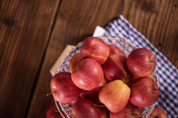 close up of red fruit apples on a wood background 