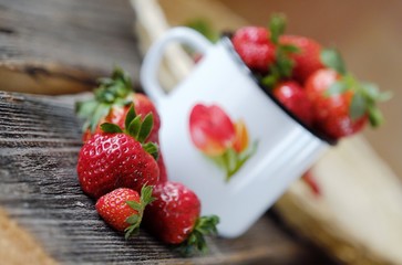 Fresh juicy strawberry in a beautiful mug on the table 