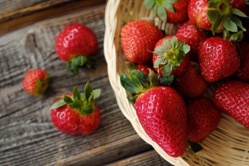 Fresh juicy strawberries in a wooden basket on the table