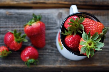 Fresh juicy strawberry in a beautiful mug on the table 