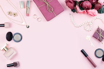 Beauty blog concept. Accessories, flowers, cosmetics and jewelry on pink background, copyspace. Womens Day concept