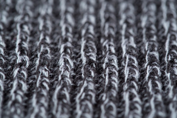 Texture of a gray knitted wool product, close up.
