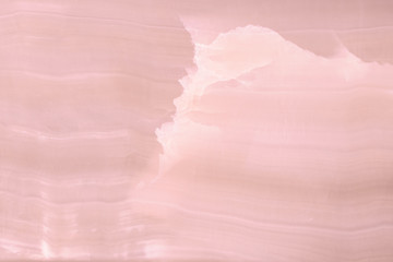 Lightened slices marble onyx. Horizontal image. Warm pink colors. Beautiful close up background