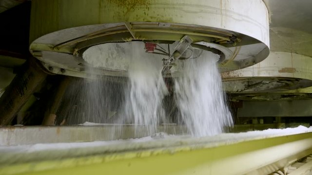 Crystal sugar moving along the conveyor belt at a sugar refinery. 4K